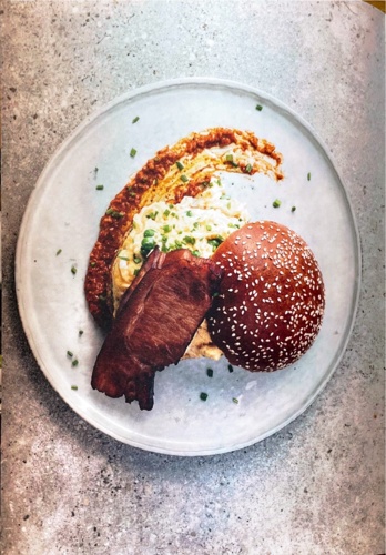 Scrambled eggs, bacon, mahón cheese, romesco