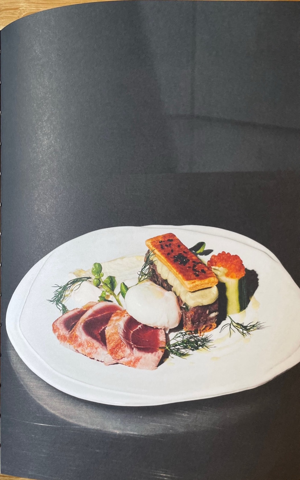 Tuna millefeuille, seared tuna, tartare of scallop & tuna, yuzu aïoli, avocado purée, pickled cucumber, poached eggs