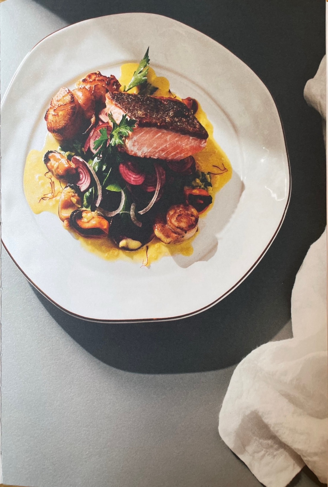 Seared ocean trout with prawn, mussel & saffron beurre blanc & baby chard salad